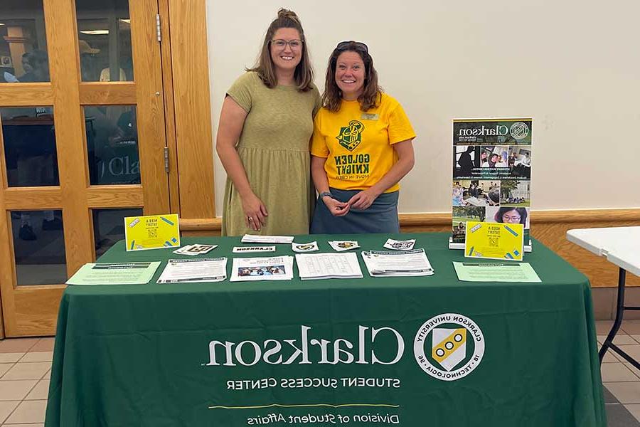 Employees from the student success center behind a table